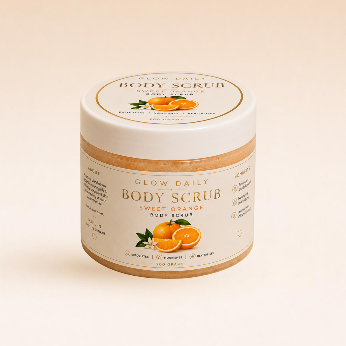 A jar of Glow Daily Sweet Orange Body Scrub with a white lid and cream-colored label, featuring illustrations of oranges and leaves, set against a warm beige background.