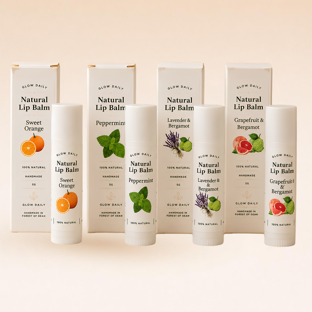 Glow Daily Natural Lip Balm tubes and matching boxes arranged on a warm beige background. The lip balms include Sweet Orange, Peppermint, Lavender & Bergamot, and Grapefruit & Bergamot flavors, each with its own colorful fruit and mint illustrations on the packaging.